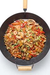 Stir-fry sea food in wok on white background, top view