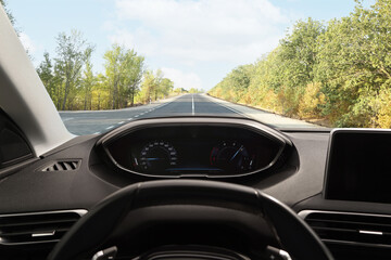 Car driving on empty road, view from driver's seat