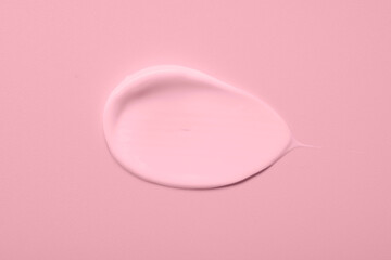 Sample of face cream on pink background, top view