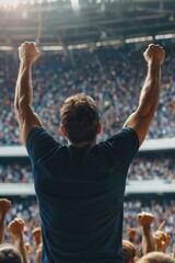 Sports event scene captures a man in navy blue t-shirt raising arms in celebration on stage surrounded by enthusiastic crowd at big stadium filled with cheering fans.
