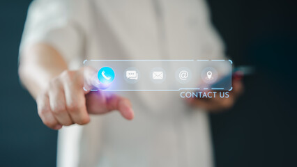 A hand touches a virtual contact interface with icons for phone, chat, email, and location. This futuristic display emphasizes communication and accessibility in the digital age.