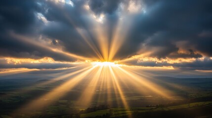 Fototapeta premium Sunlight streaming through a break in the clouds, casting rays of light down onto a quiet landscape below