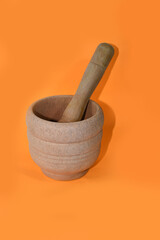 Mortar with pestle for grinding made of natural wood on a isolated  colorful background,
mortar and herb spices 
top view, front view close up 