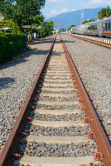 Fototapeta premium railway in the countryside, railroad tracks in the countryside, railway in Indonesia, train and railway, railway in the mountains, railway tracks, railway in the village, travel by train in Indonesia