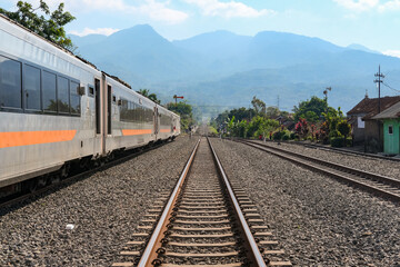 Obraz premium railway in the countryside, railroad tracks in the countryside, railway in Indonesia, train and railway, railway in the mountains, railway tracks, railway in the village, travel by train in Indonesia