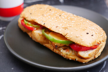 A Delightful and Delicious Chicken Sandwich Accompanied by Fresh Vegetables on a Plate