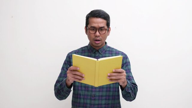 A man showing shocked face expression after read a book