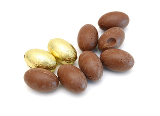 Chocolate easter eggs in colorful foil on white background