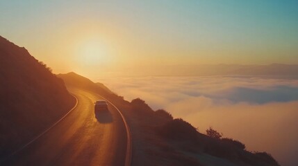 Fototapeta premium A Car drive on the highest road of the mountain. left running lane There is fog floating below the road. The sun is behind. 