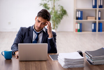 Young male employee working in the office