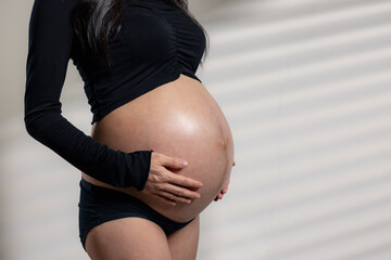 Pregnant woman with her tummy