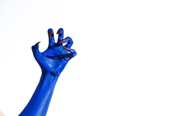 A witch's blue hand with sharp red nails on a white background. It exudes a demonic, monstrous vibe, blending vampire, alien, and ghostly features, creating a perfect Halloween horror image.