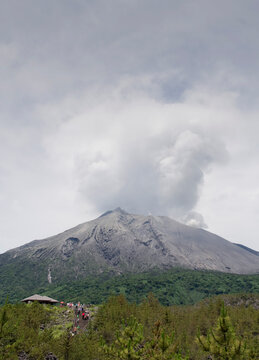 Kagoshima Prefecture, Japan - October 8, 2015: Tourist are on Arimura Lava Observatory looking at smoke of Sakurajima Volcano