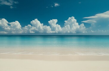 Fototapeta premium Tranquil beach scene with soft, white sand, gentle waves, and a clear blue sky with fluffy clouds.