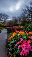 A walkway is lined with a variety of colorful flowers