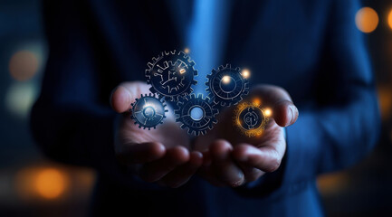 A person is holding a hand full of gears, possibly representing a machine or a complex system. Concept of complexity and the importance of understanding the inner workings of such systems