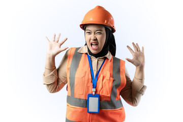 Young Asian female construction worker wearing hijab looks very scared while covering her face with her hands, frightened gesture, industrial and construction concept, isolated puith background.