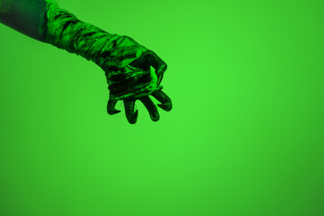 A bloodied witch hand wrapped in bandages, set against a green fire background. This demonic hand blends elements of vampires,aliens, and ghosts, evoking a spooky, monstrous feel perfect Halloween