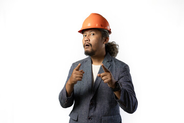 the happy expression of a boss pointing. stylish asian man with suit and orange helmet on white background. construction or mining business concept 