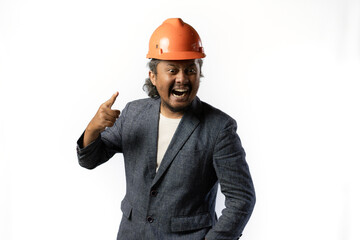expression of a boss's unacceptability, stylish asian man with suit and orange helmet on white background. construction or mining business concept photo