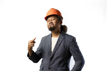 project leader gestures with a middle finger.  stylish asian man with orange suit and helmet on white background. construction or mining business concept photo