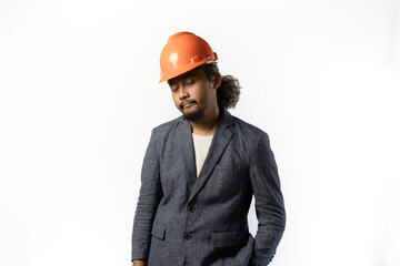 project leaders who look tired and pessimistic. stylish asian man with orange suit and helmet on white background. construction or mining business concept photo