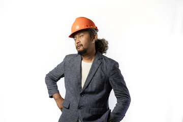 project leaders who look tired and pessimistic. stylish asian man with orange suit and helmet on white background. construction or mining business concept photo