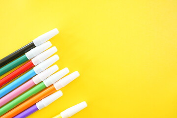 Colorful Markers on Yellow Background