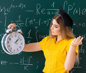 Young female student in front of the chalkboard