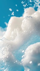 Fototapeta premium White foam bubbles in blue water