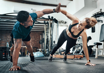 Workout, personal trainer and friends high five for wellness, exercise and training on gym floor. Healthcare, warm up and woman with fitness, coach and body performance routine for core muscle goals