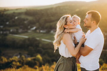 Happy Family Enjoying a Scenic Outdoor Moment in Golden Sunset Light