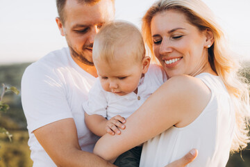 Happy Family Enjoying a Pleasant Day Outdoors with Smiling Parents and Baby