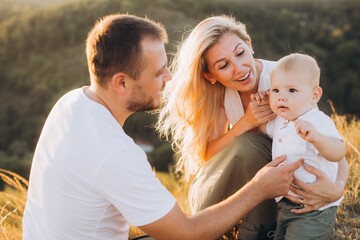 Happy Family Enjoying a Beautiful Day Outdoors with Their Adorable Baby