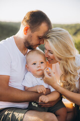 Fototapeta premium Happy Family Enjoys Quality Time Outdoors in Sunlit Natural Setting