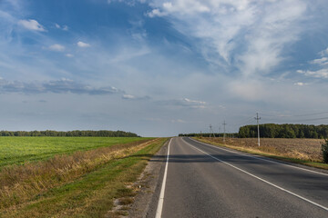 Fototapeta premium A long road with a clear blue sky above it