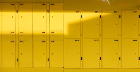 A row of yellow lockers with numbers on them. yellow smart locker.