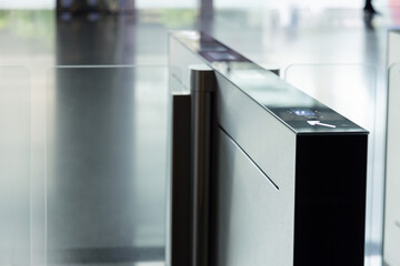 A black and silver electronic device with a green arrow pointing to the right. smart turnstiles.