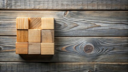 Wooden blocks arranged on rustic wood table in shades of gray