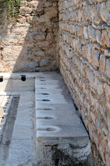 Ancient public Toilet bathroom seats on Ephesus , public toilets used in ancient times, sitting toilets side by side