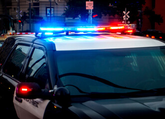 Close up of a police car with emgergency lights activated in an urban environment © F Armstrong Photo