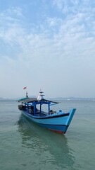 Bandar Lampung, Indonesia - September 1st 2024: Fishing boats are parked on the seashore in the afternoon with a cloudy sky in the background