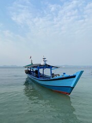 Bandar Lampung, Indonesia - September 1st 2024: Fishing boats are parked on the seashore in the afternoon with a cloudy sky in the background