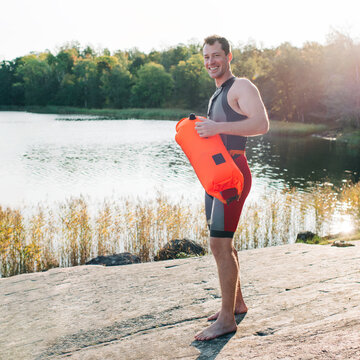 man ready to go swimming in the sea with his friends