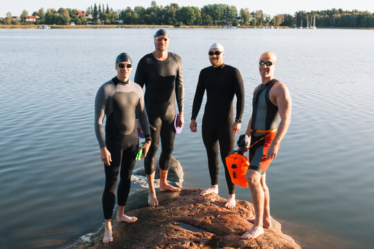 Swedish men stood on a rock ready to swim in the baltic sea