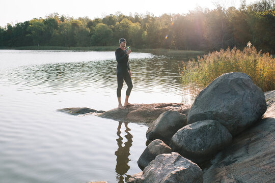 Scandinavian man drinking tea after swimming in the sea