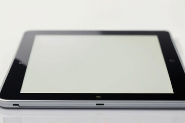 Digital Tablet with Blank Screen on White Surface