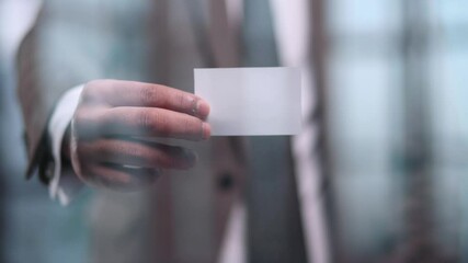 Handsome young man giving business card in modern office