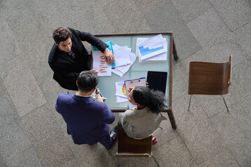 Businessman present a new mainboard product to partner and team for make a deal on desk  and aerial...