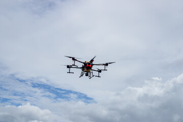 Agriculture drone fly to sprayed fertilizer on the green corn fields